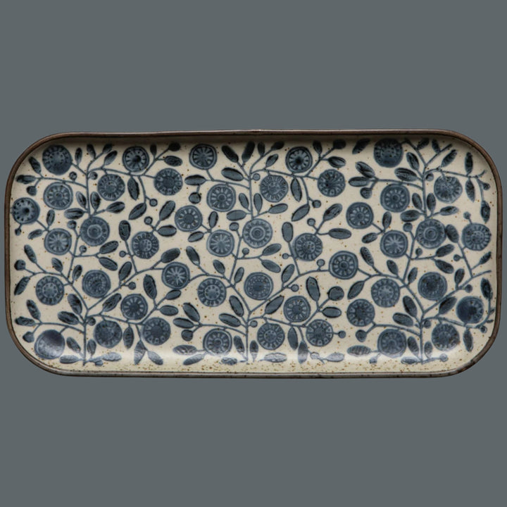 Rectangular ceramic tray with blue floral pattern on a white background