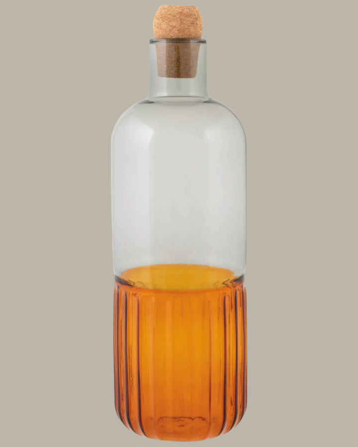 Glass bottle with cork stopper on a white background
