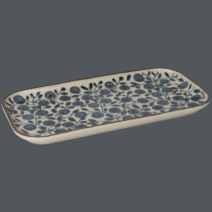 Rectangular ceramic tray with blue floral pattern on a blue background