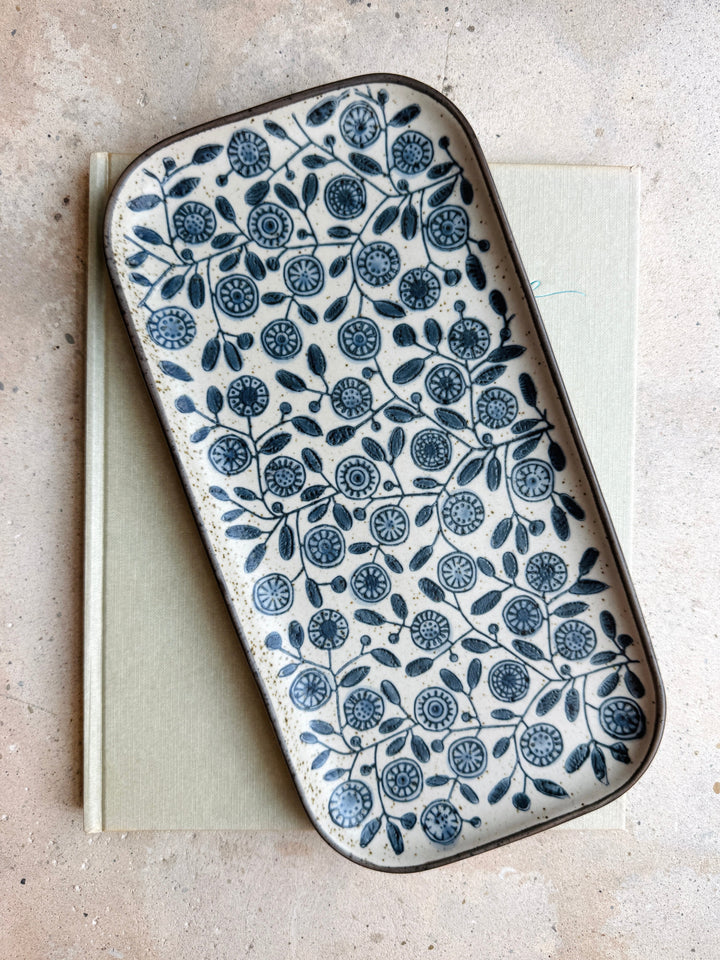 Decorative tray with blue floral pattern on a light background
