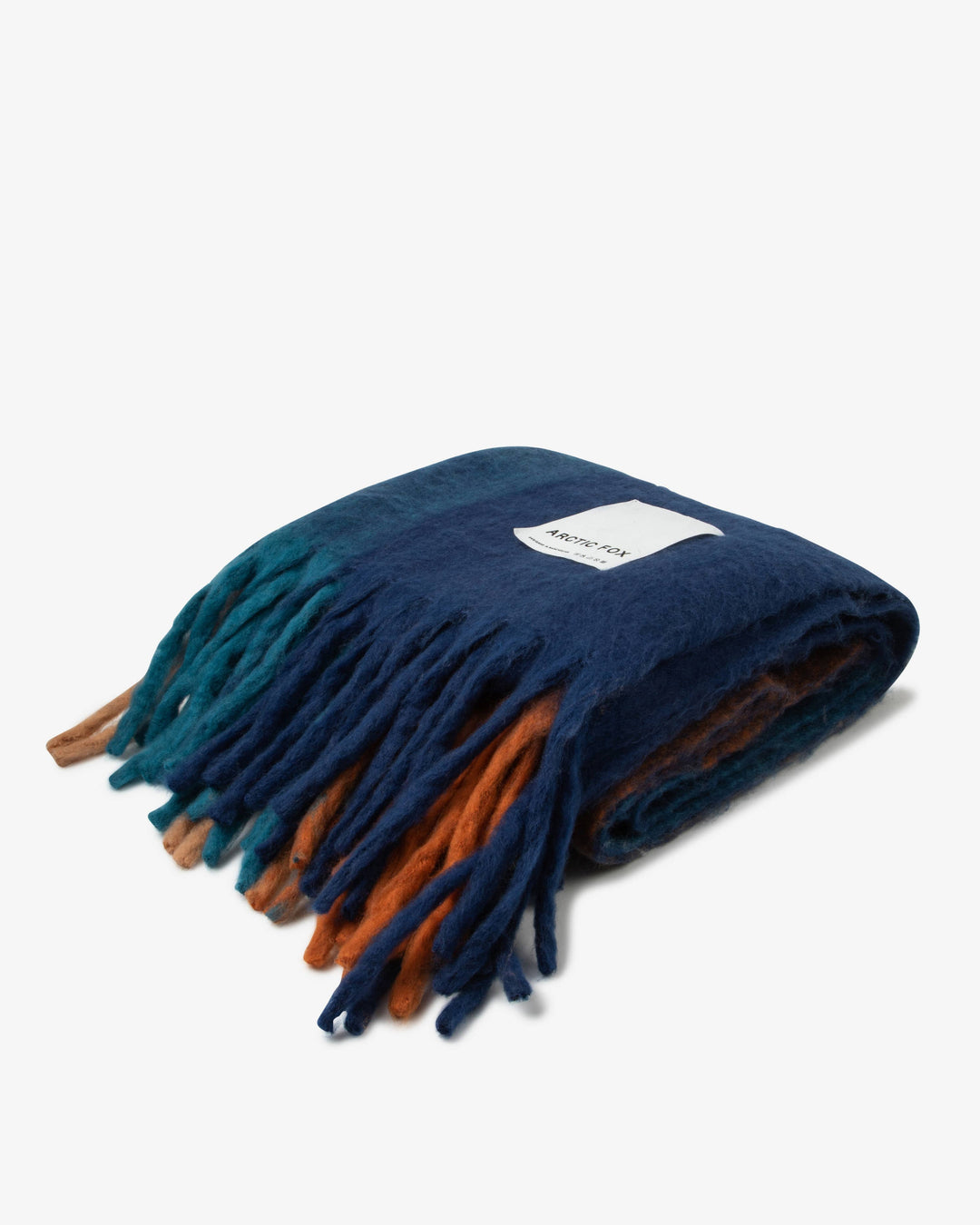 Navy blue and orange blanket with fringe on a white background