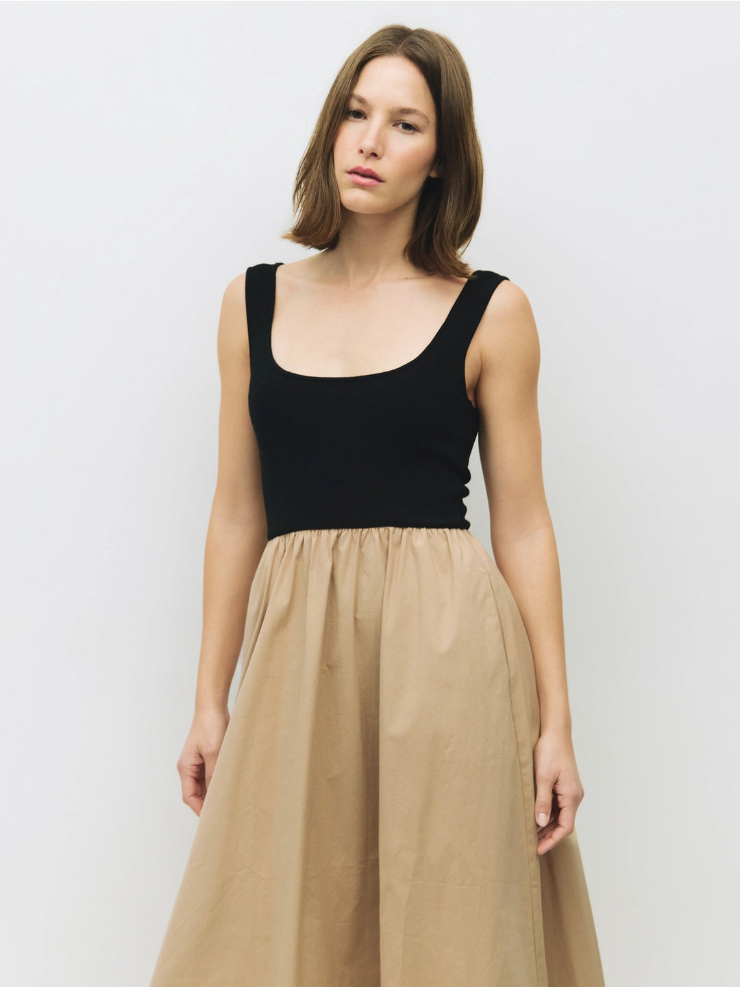 Woman wearing a black and beige cotton dress on a white background sold at shopwinsome.com a cute boutique based in chicago IL in the avondale neighborhood.