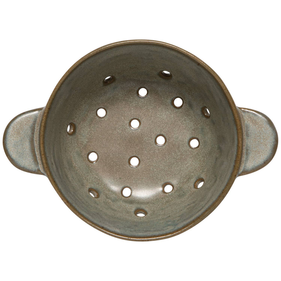 Ceramic colander with handles on a white background