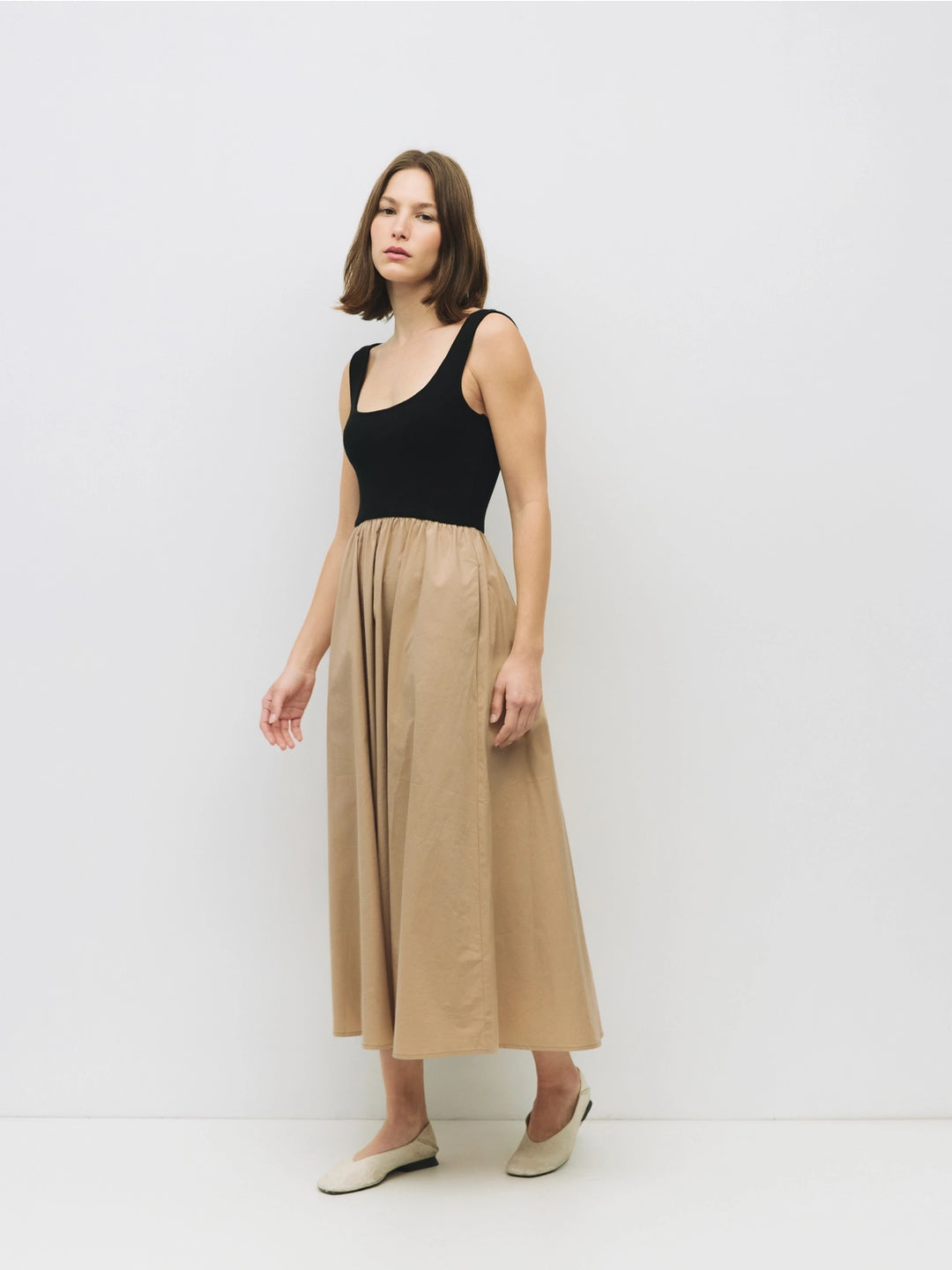 Woman wearing a black and beige cotton dress on a white background sold at shopwinsome.com a cute boutique based in chicago IL in the avondale neighborhood.