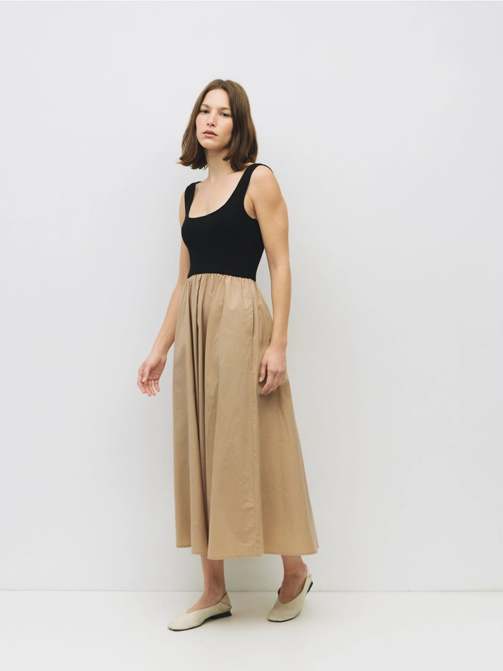 Woman wearing a black and beige cotton dress on a white background sold at shopwinsome.com a cute boutique based in chicago IL in the avondale neighborhood.