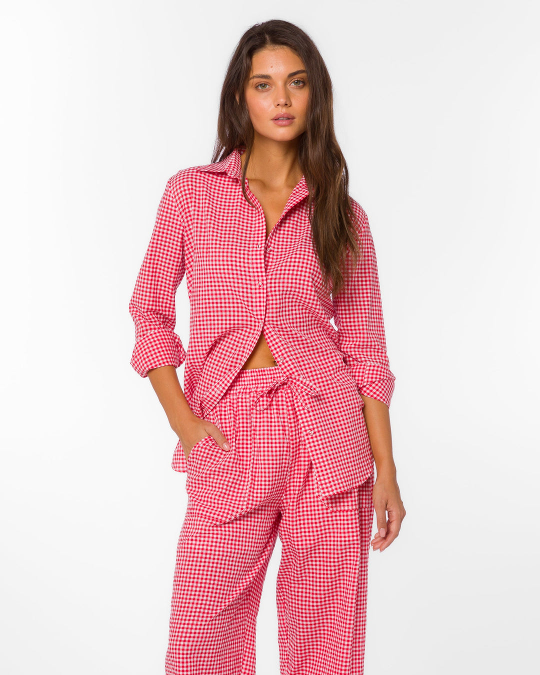 Woman wearing a red gingham checkered outfit on a white background