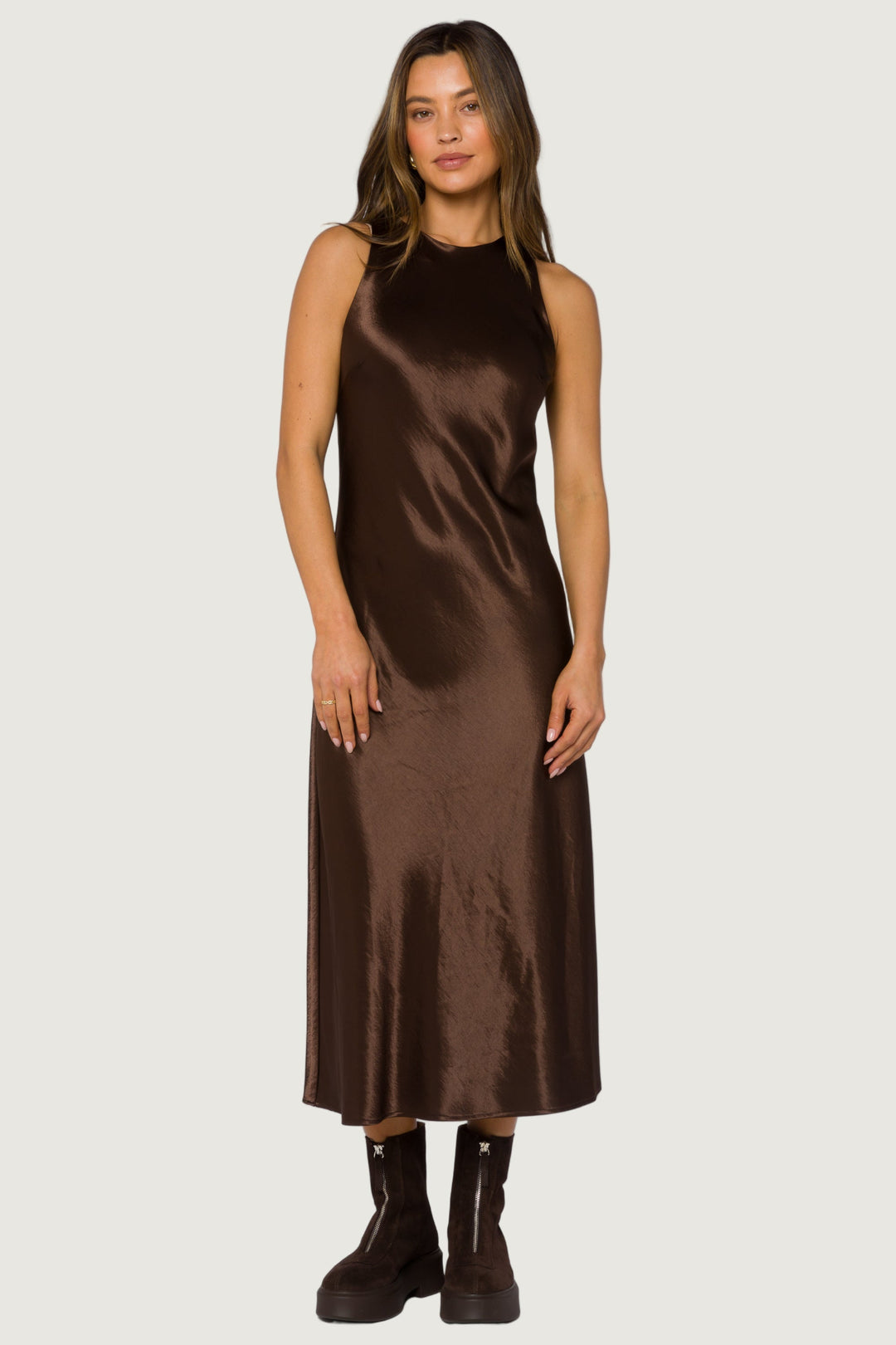 Woman wearing a brown satin dress on a white background