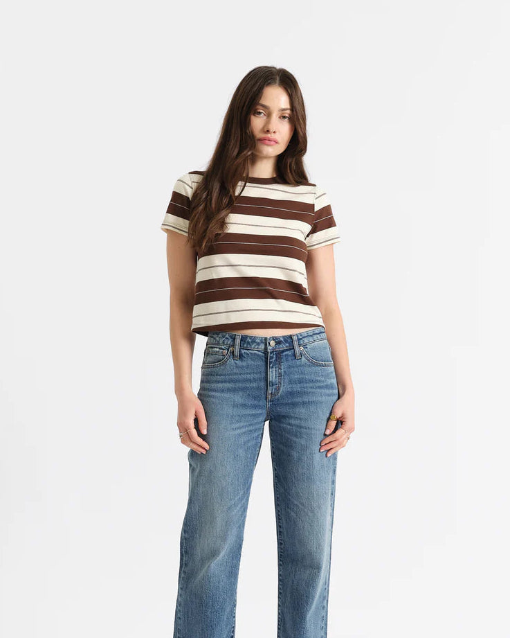 Woman wearing a striped shirt and blue jeans on a white background