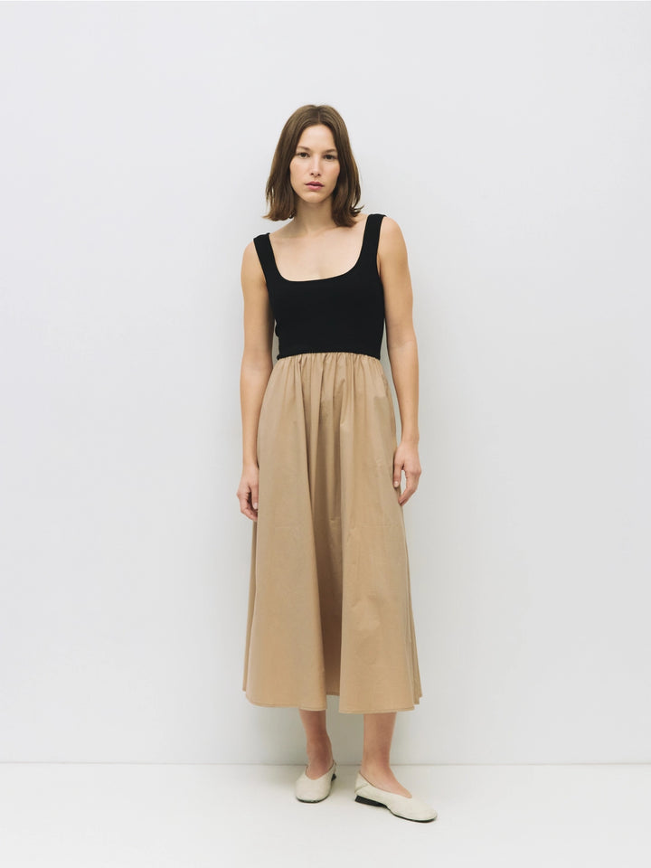 Woman wearing a black and beige cotton dress on a white background sold at shopwinsome.com a cute boutique based in chicago IL in the avondale neighborhood.