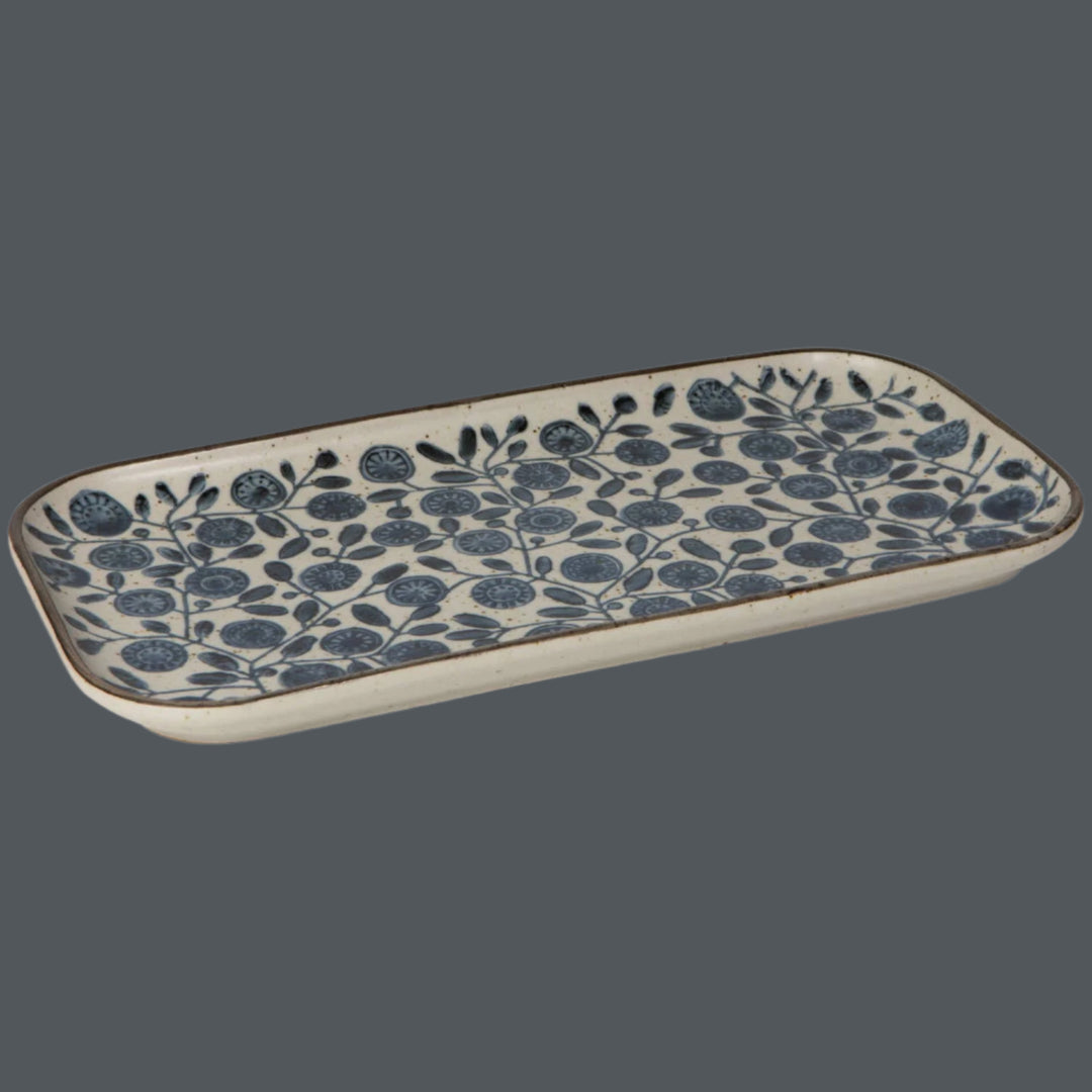 Rectangular ceramic tray with blue floral pattern on a blue background
