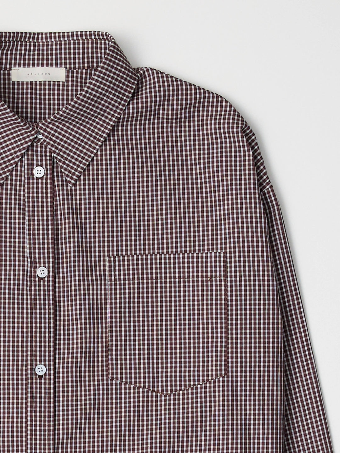 Checkered shirt with a collar and pocket on a light gray background