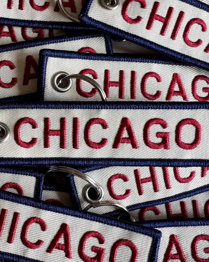 Multiple 'Chicago' keychains with red text on a white background