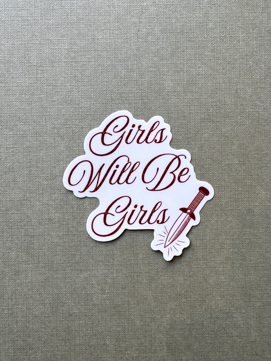 A die-cut vinyl sticker with the phrase &