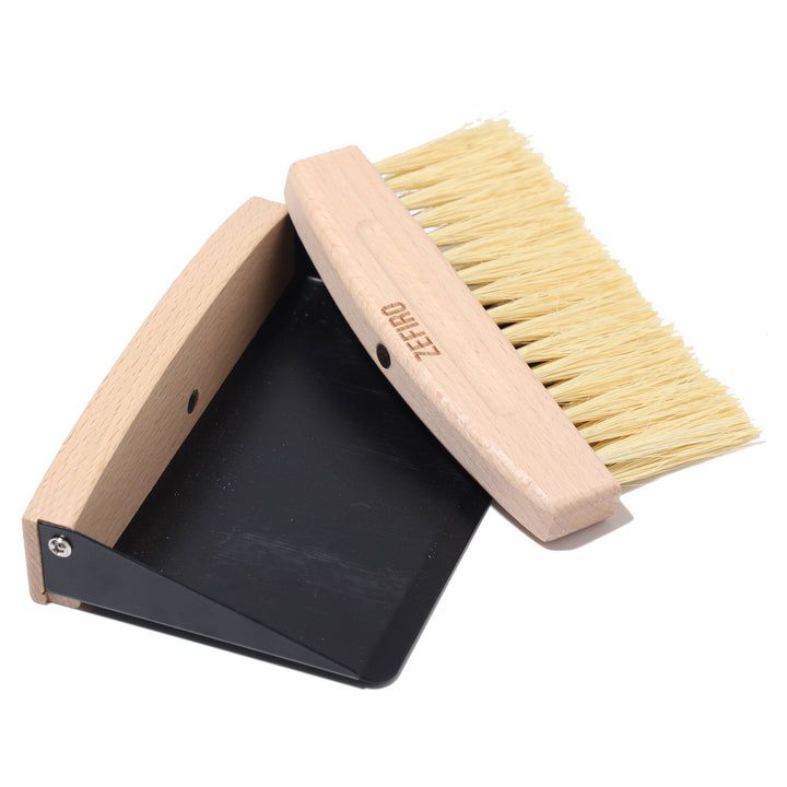 Cleaning brush with a dustpan on a white background