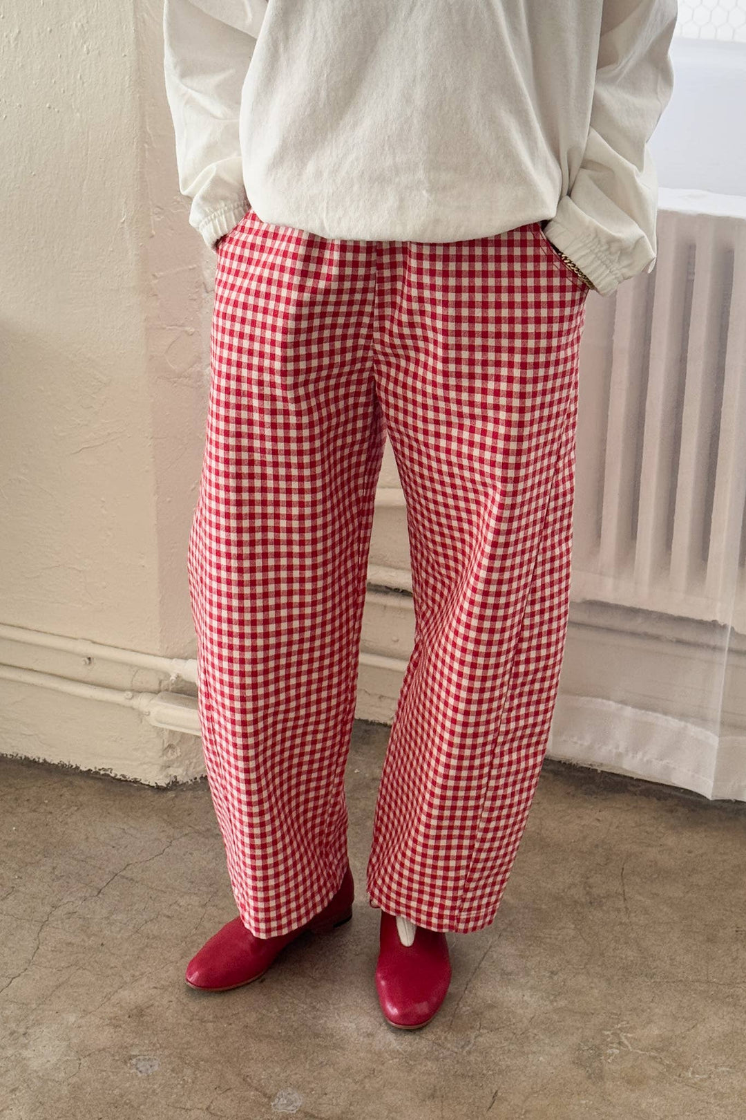 Person wearing red checkered pants and red shoes sold at shopwinsome.com a cute boutique based in chicago il