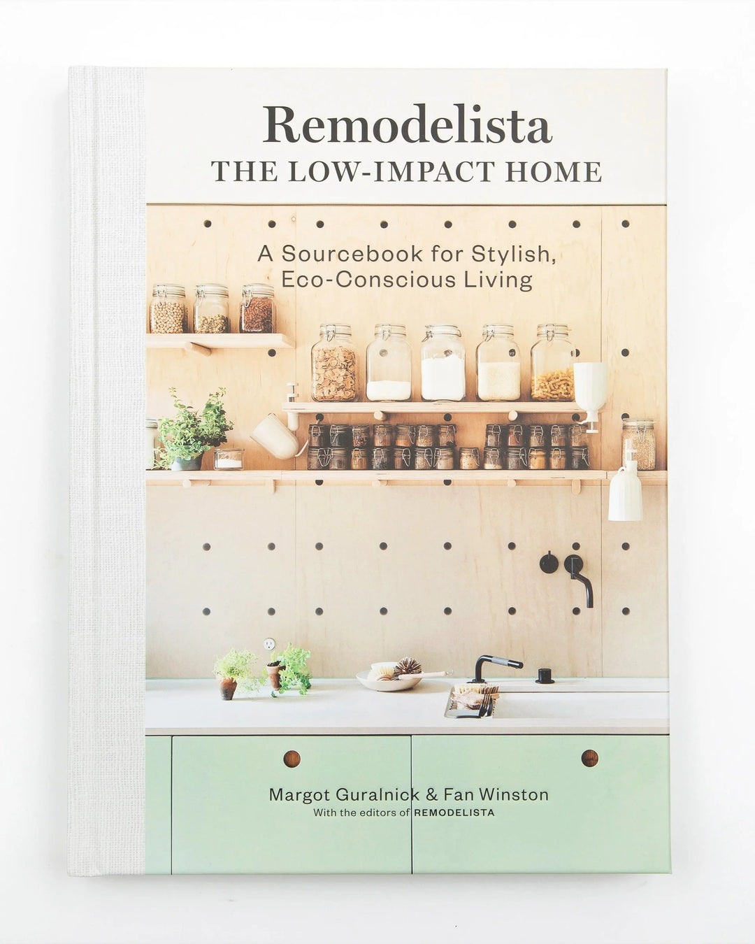 Book cover of 'The Low-Impact Home' by Remodelista with a kitchen scene on the cover.