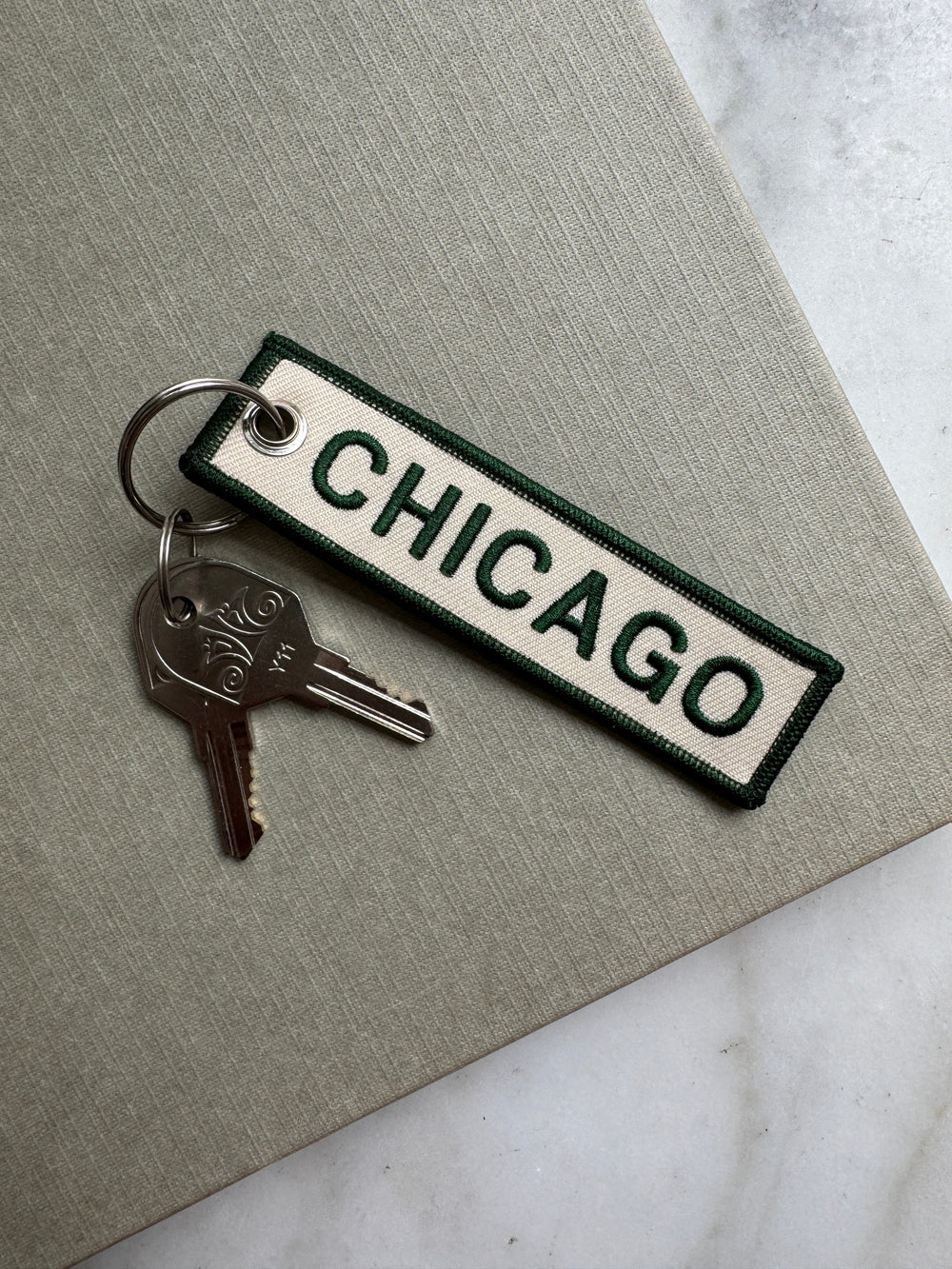 Keychain with 'Chicago' text on a gray surface