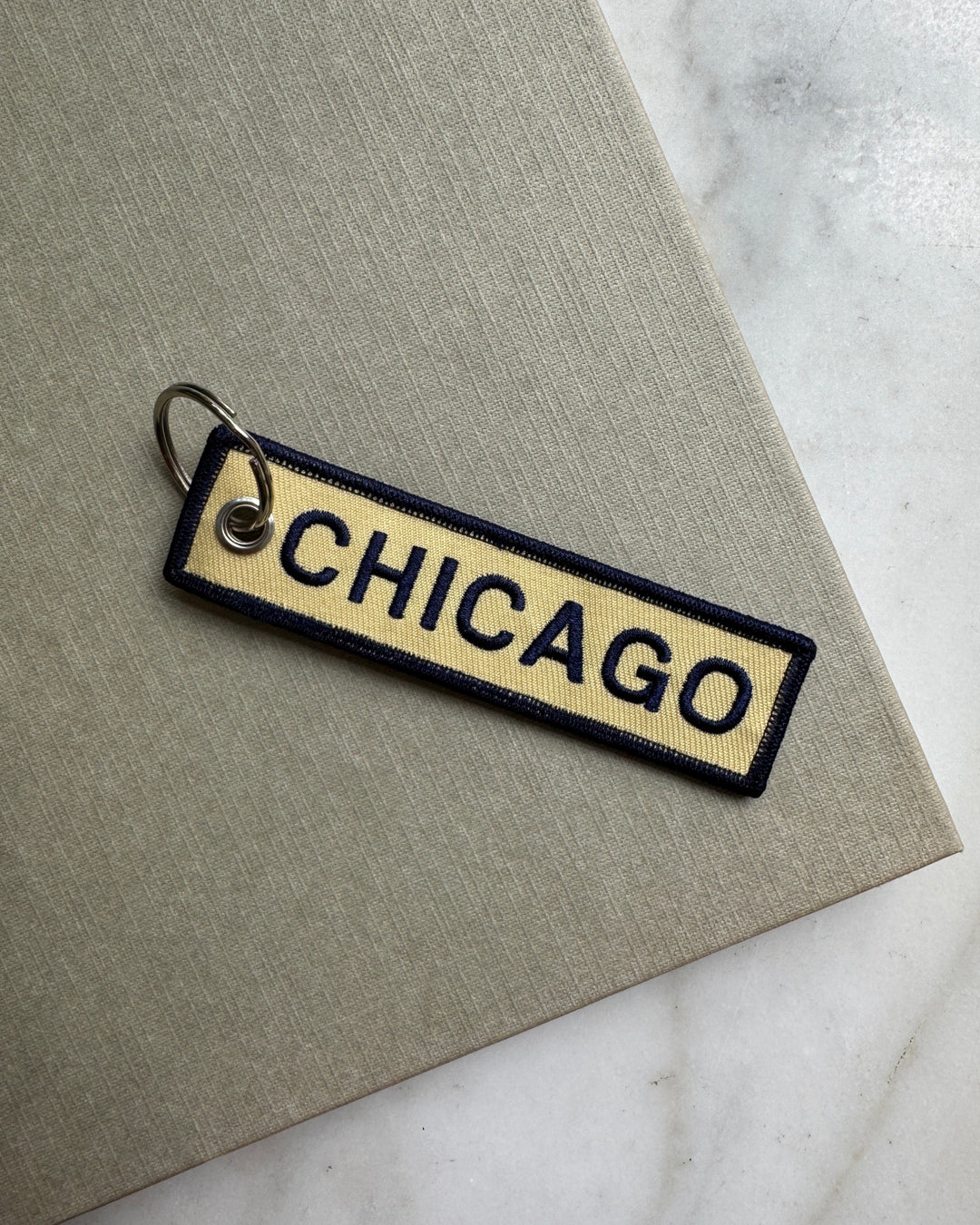 Keychain with 'Chicago' text on a textured surface