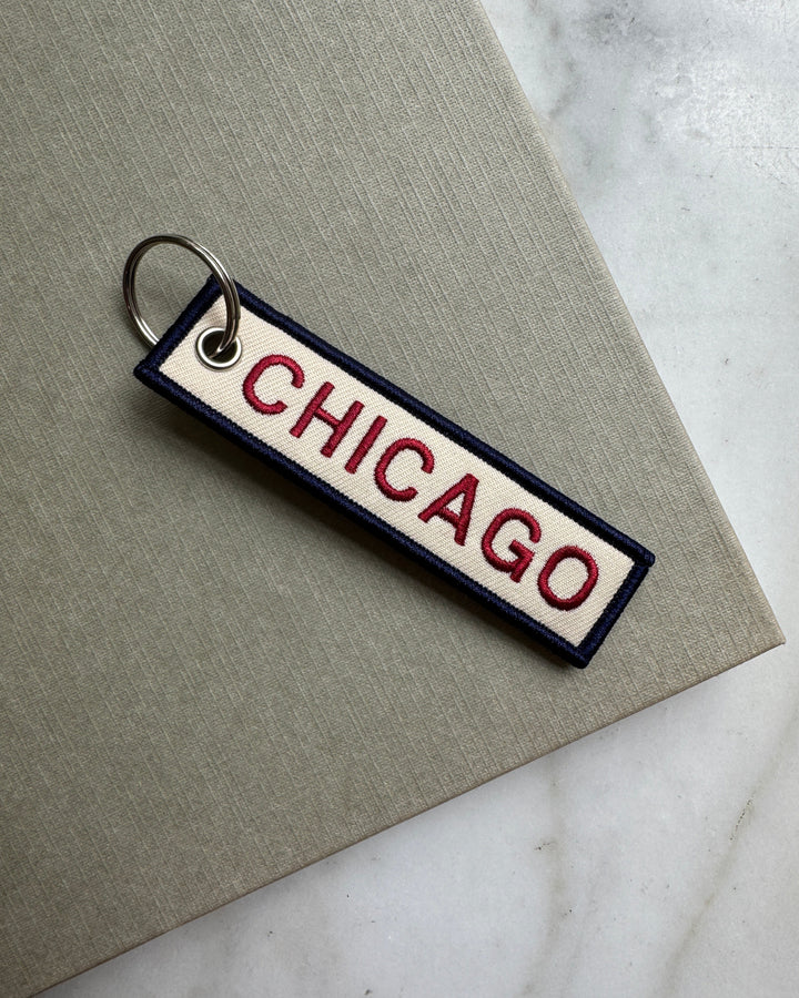 Keychain with 'Chicago' text on a marble surface